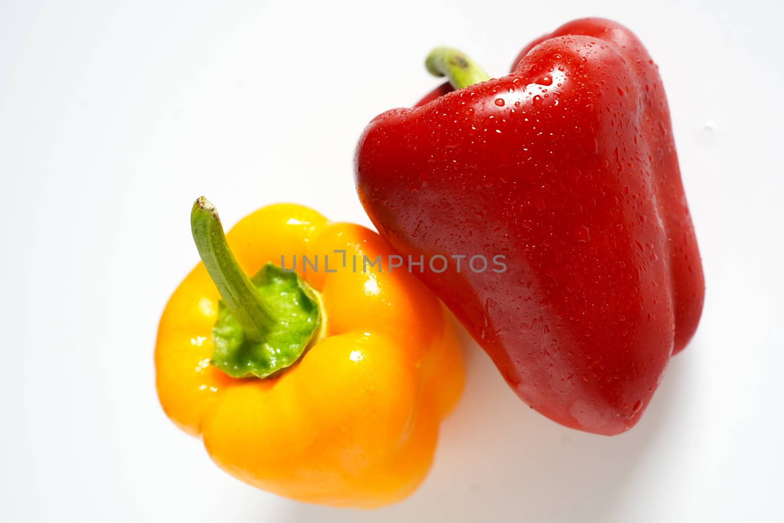 A red and yellow pepper against a plain white background