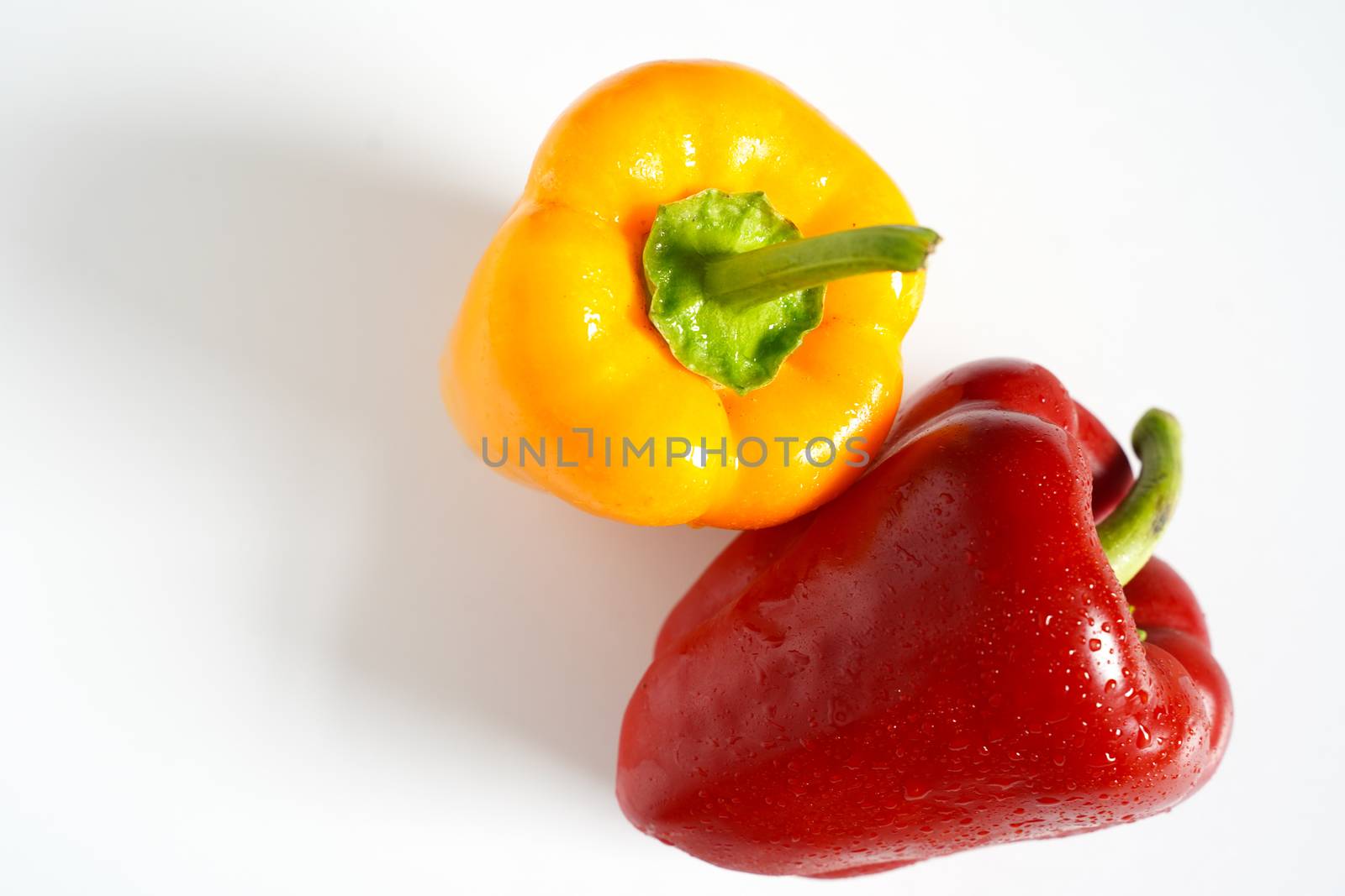 A red and yellow pepper against a plain white background