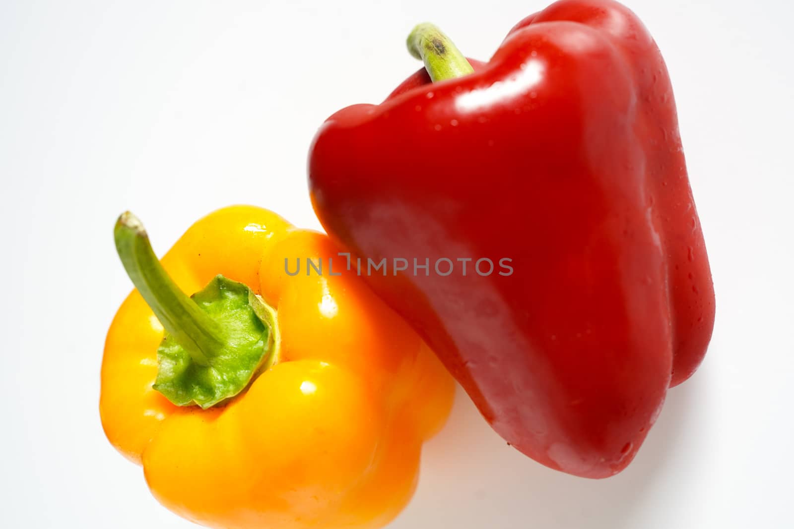 A red and yellow pepper against a plain white background