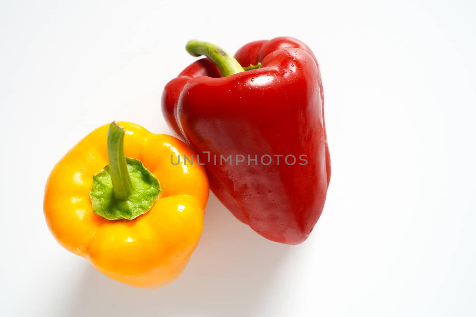 A red and yellow pepper against a plain white background