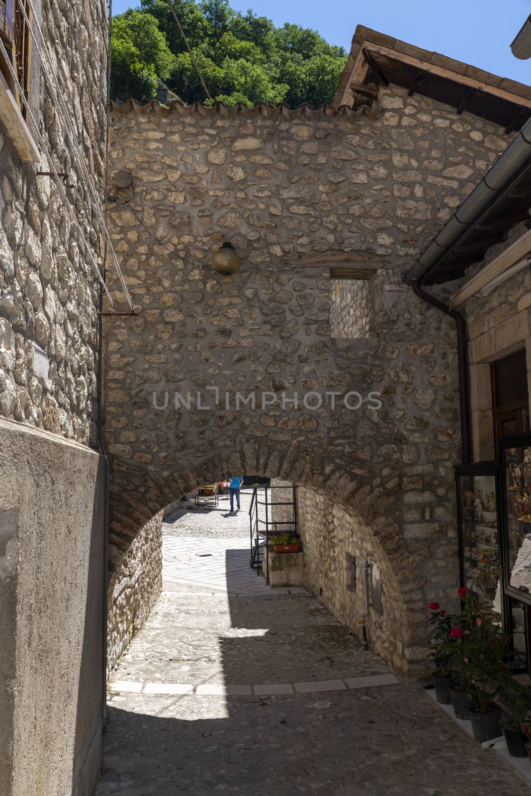 rocca porena,italy july 05 2020:arch on the alley to access the path to go to the rock sanctuary in rocca porena