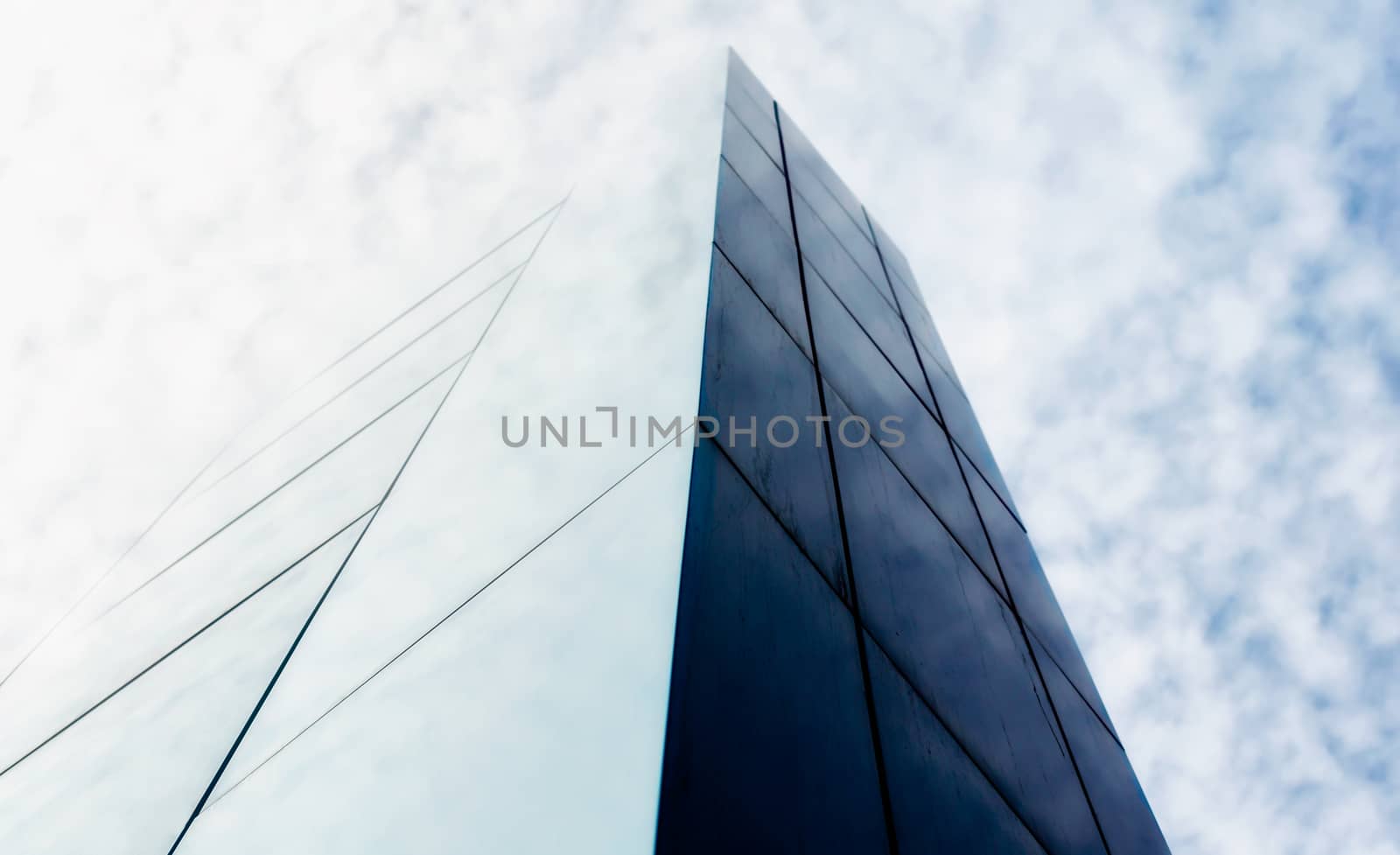 wall of a modern building against the sky and clouds abstract architectural background