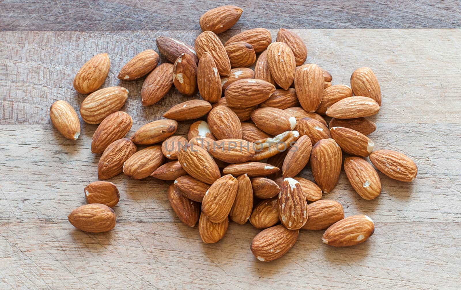 almonds on a wooden background by sirspread