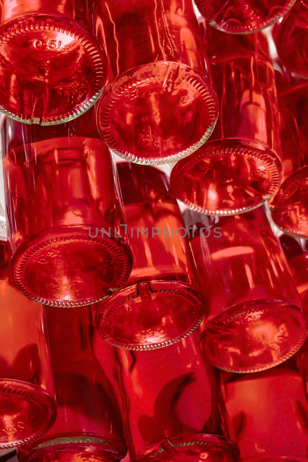 Drinks bottled and stored in stack. Bottles of red beverage stored on special shelf. Alcohol, non-alcohol drinks in 0.5 liter bottels. View from below. Bottles of wine in winery. Beverage industry by synel