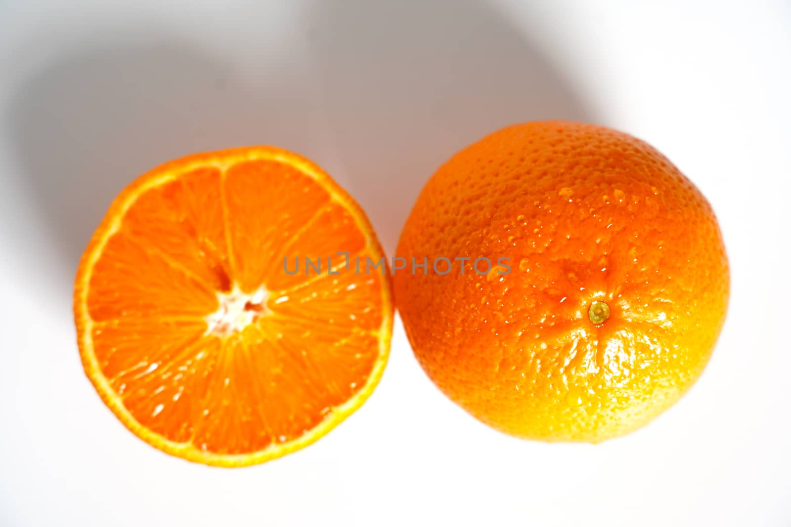 A Sliced Orange against a plain white background by samULvisuals