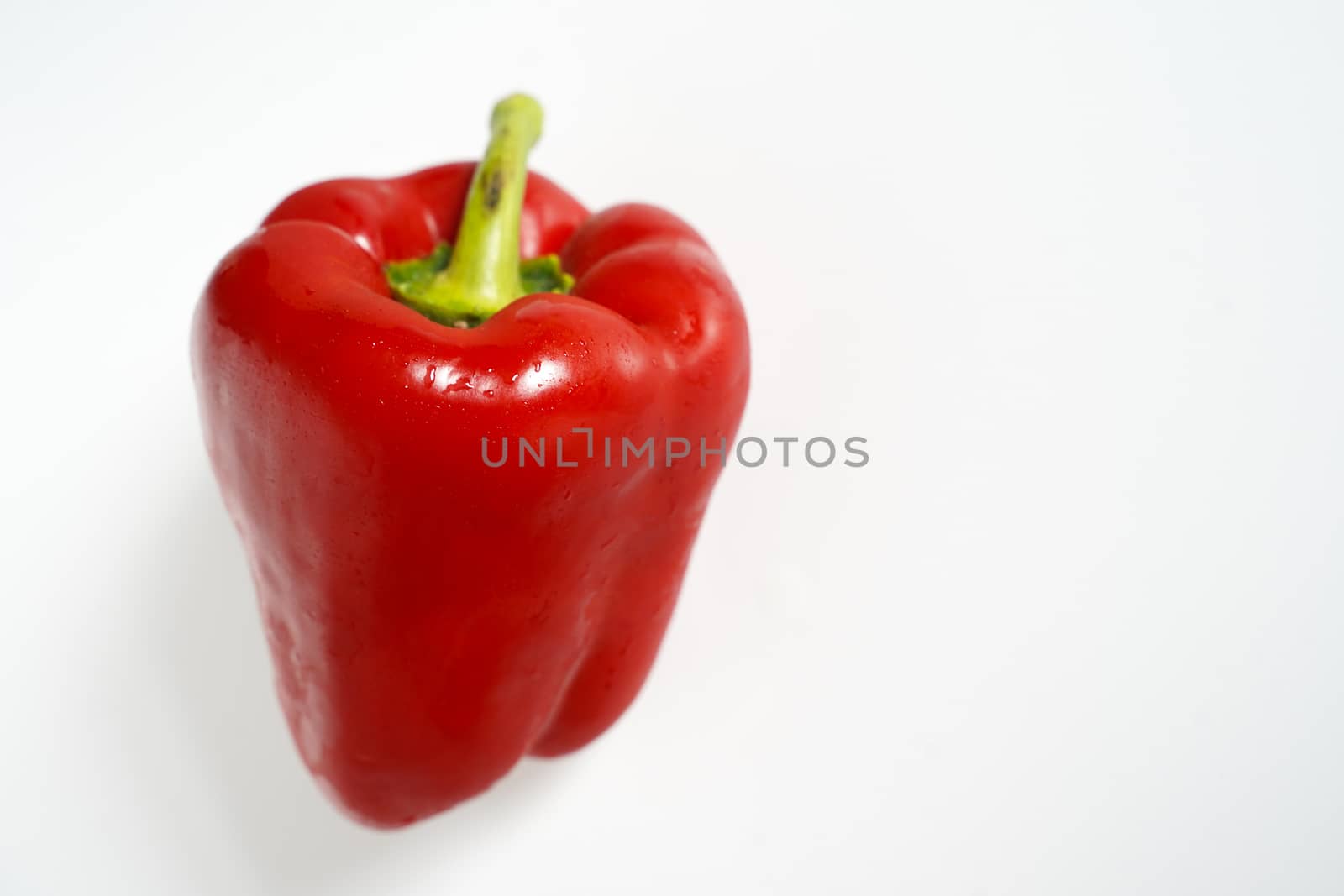 A red pepper against a plain white background