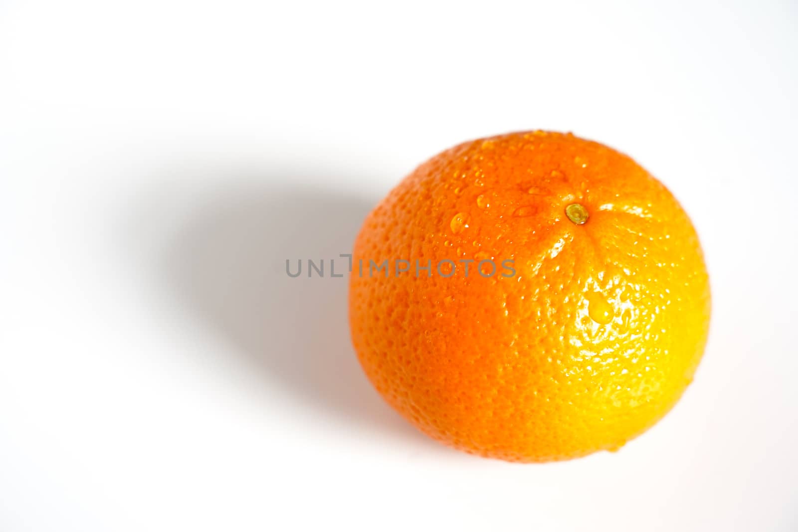 A whole orange against a plain white background