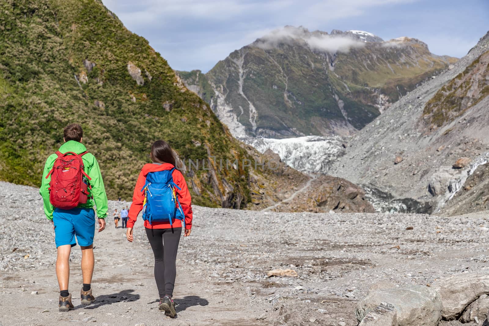 New Zealand tourists backpacking in nature by Franz Josef Glacier by Maridav