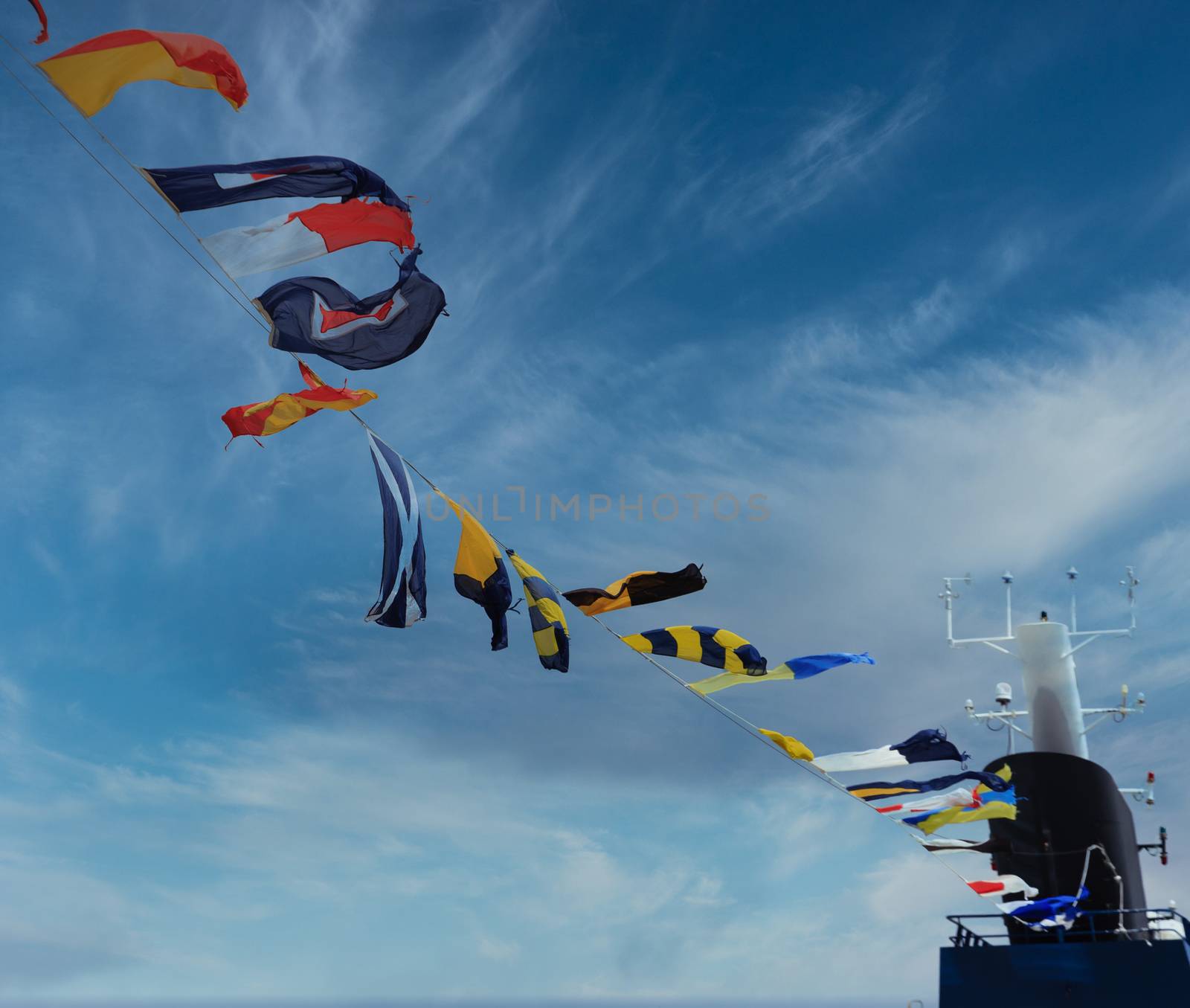 Nautical Flags Under Clouds and Wind