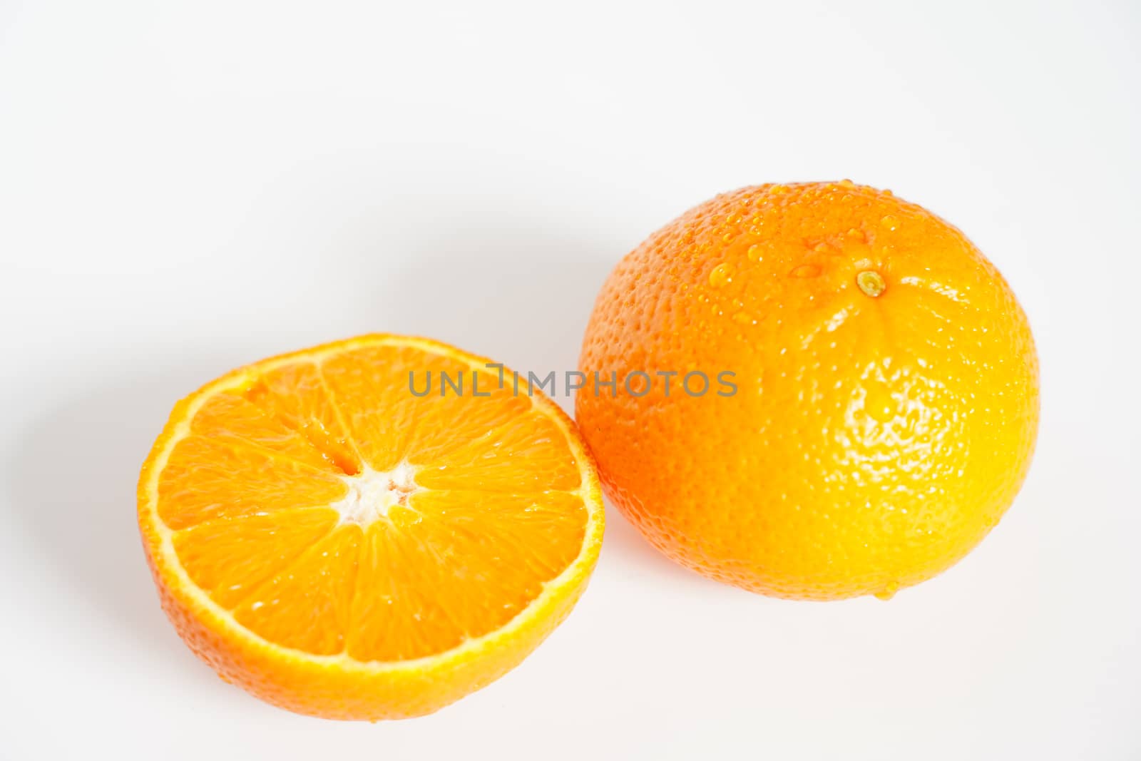 An orange sliced in half against a plain white background