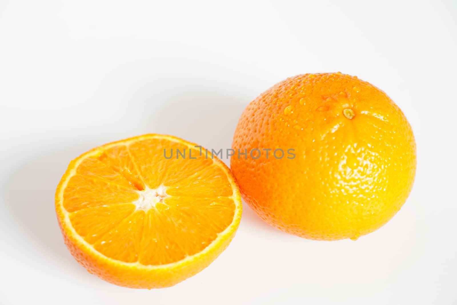 An orange sliced in half against a plain white background