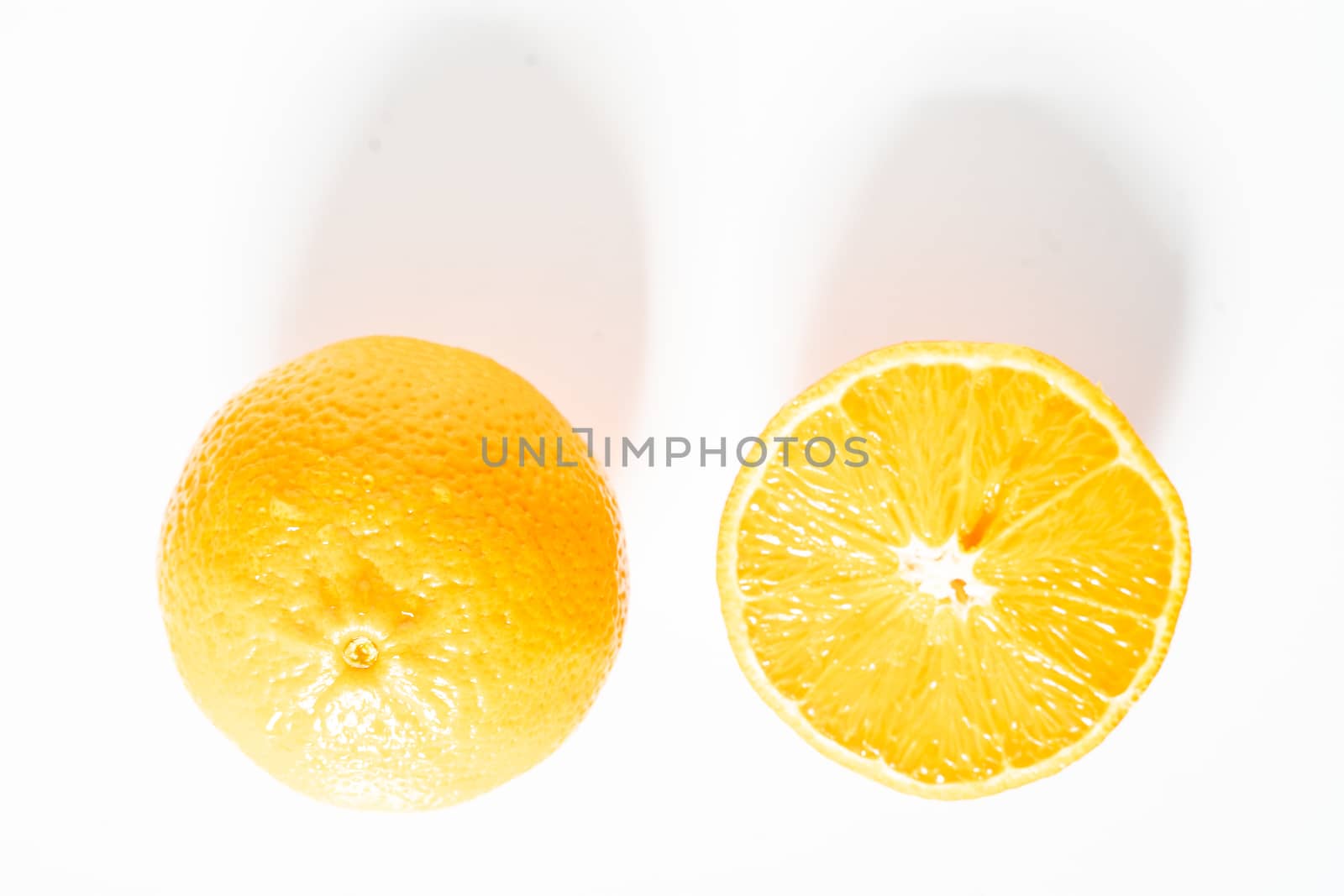 An orange sliced in half against a plain white background