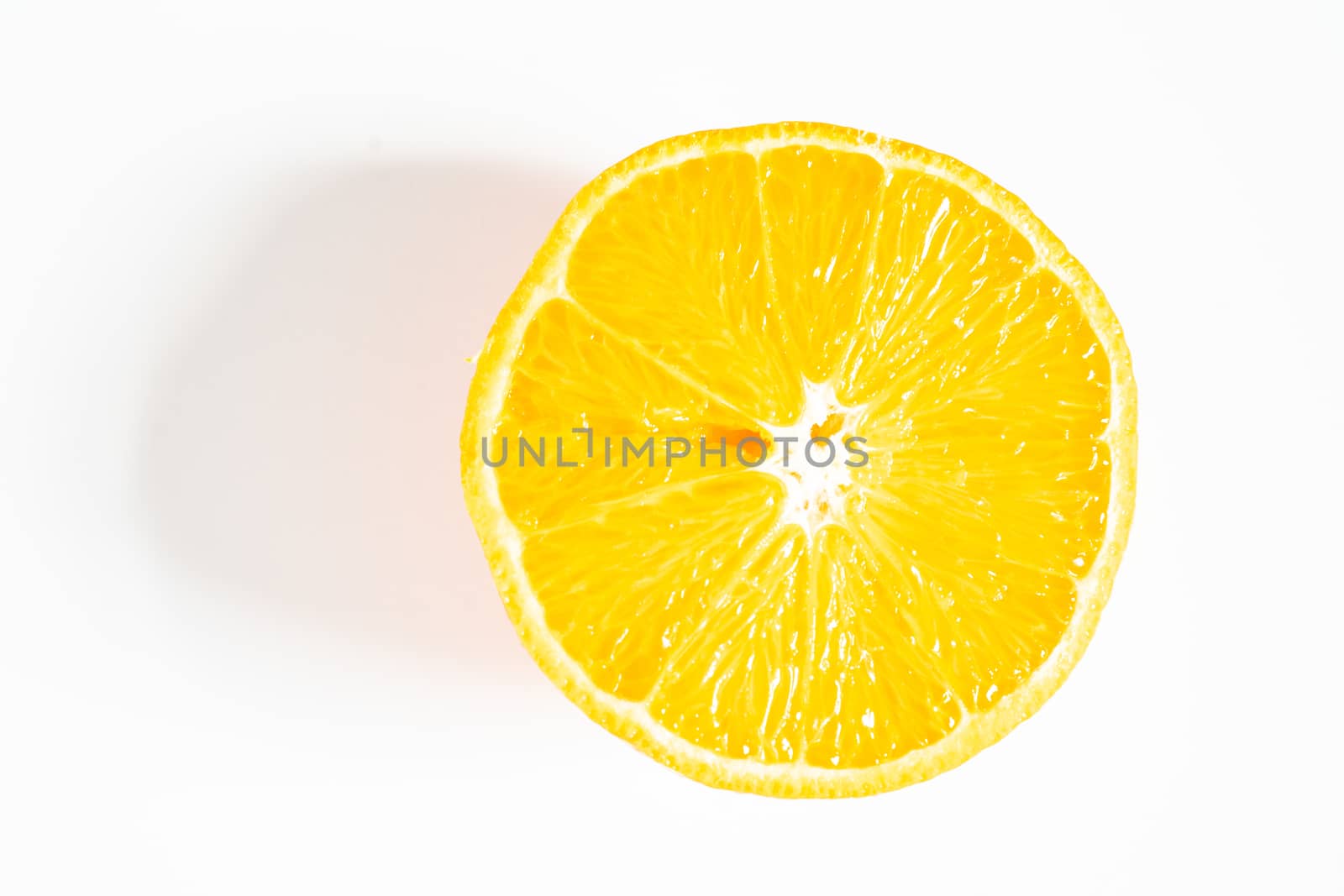 An orange sliced in half against a plain white background