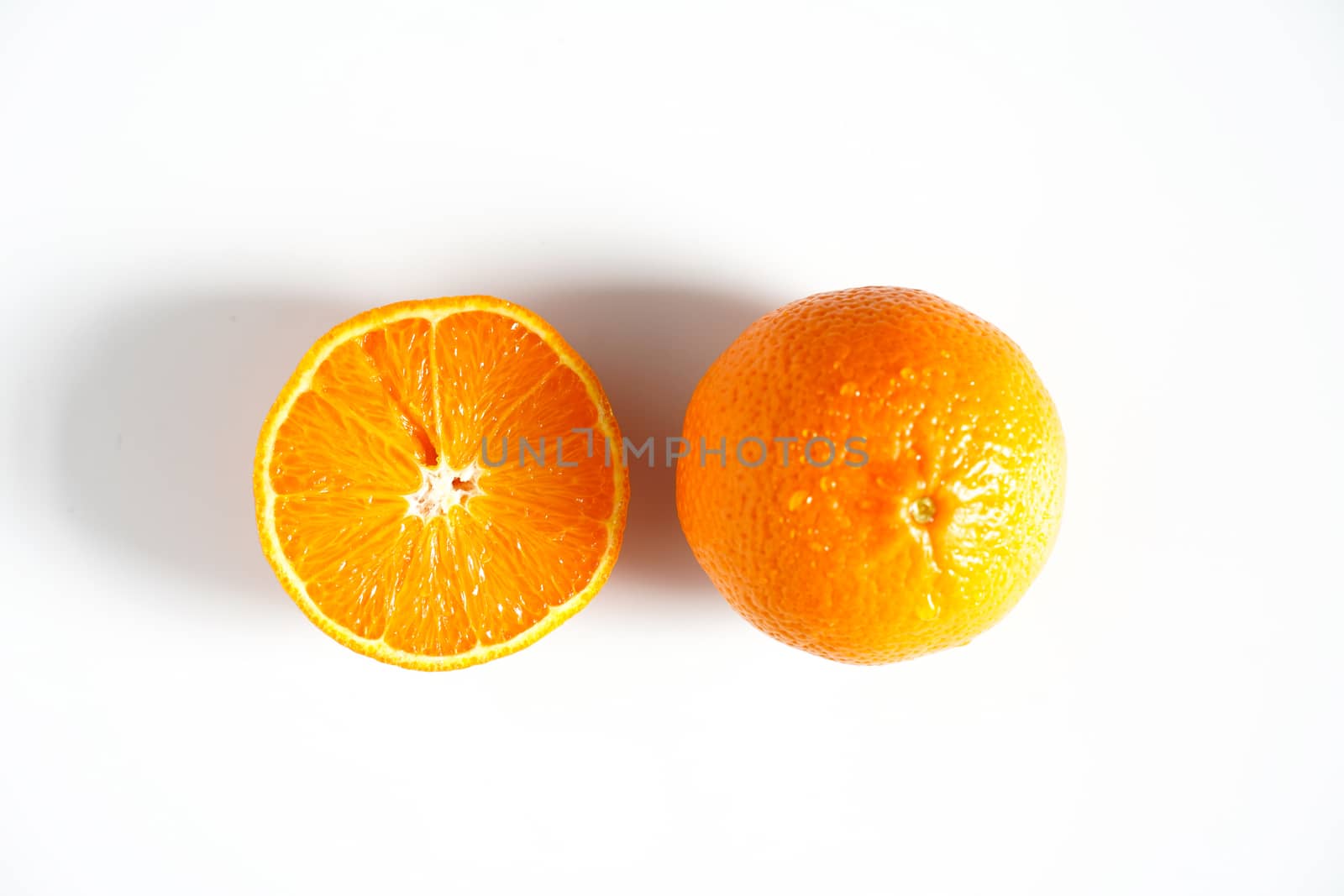 An orange sliced in half against a plain white background