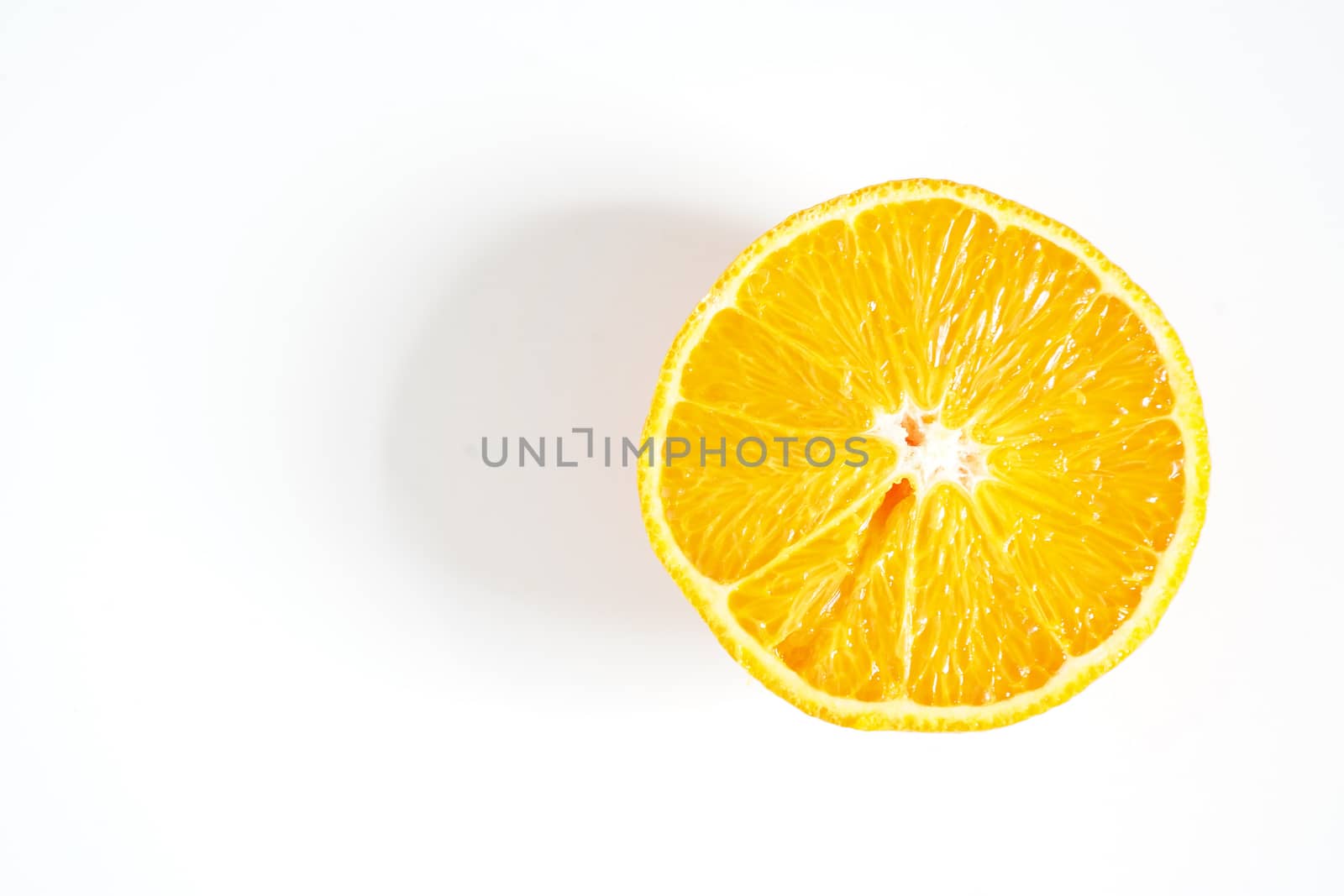 An orange sliced in half against a plain white background