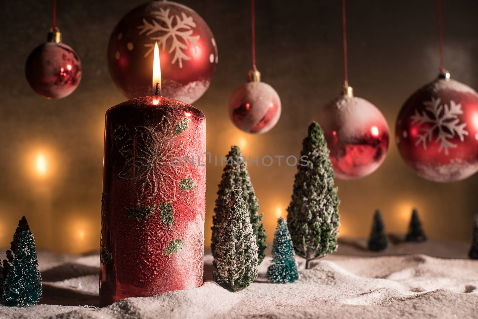Christmas decoration with burning candles on a dark background. Christmas ornaments over dark golden background with lights. Creative artwork decoration.
