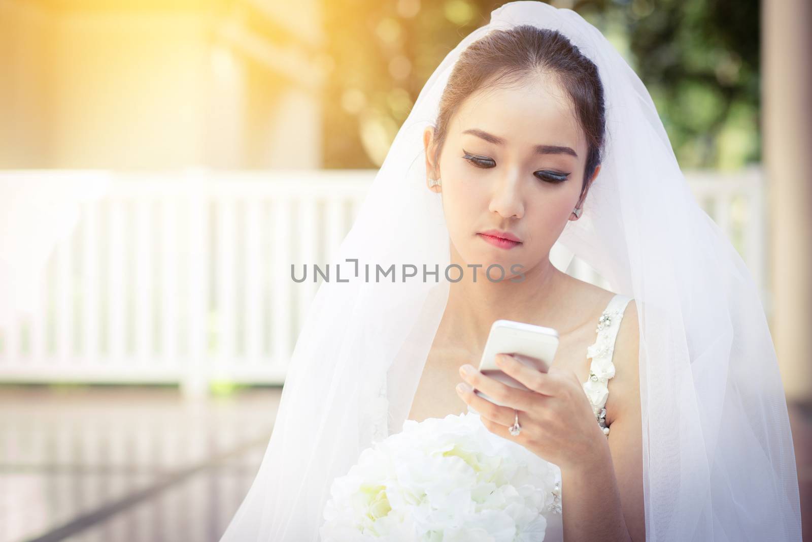 bride talking on cell phone in wedding dress