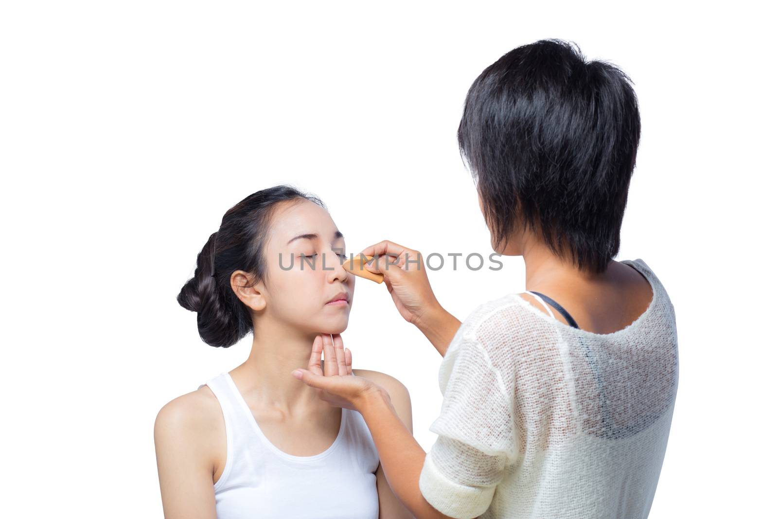 Young lady applying blusher on her face with powder puff, skin c by nnudoo