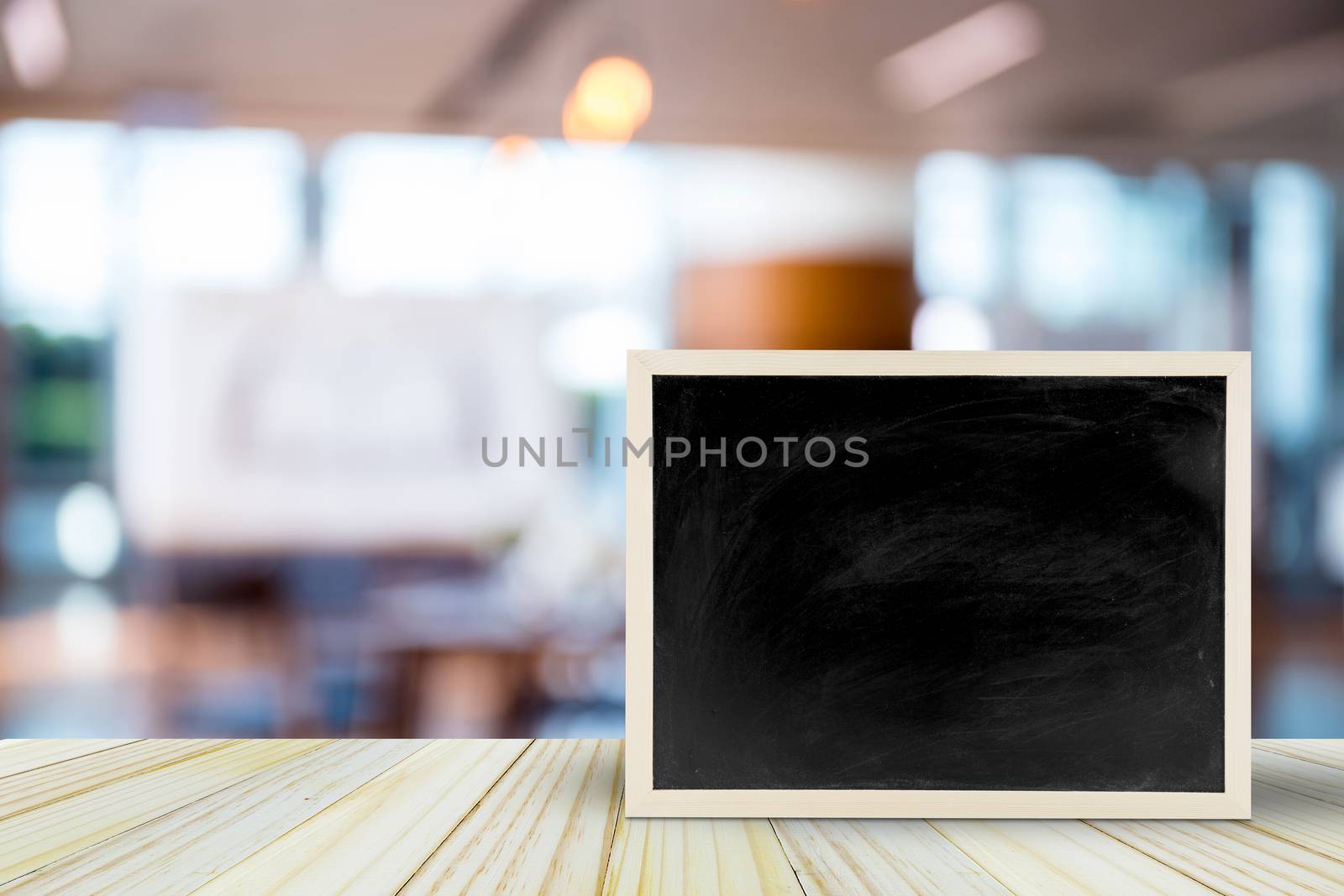 Blank chalkboard on table over blur restaurant with bokeh background, space for text, mock up, product display montage