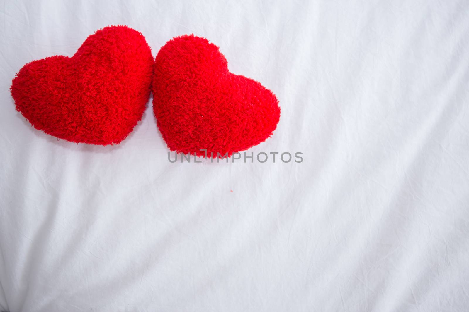 Romantic interior for Valentine's day with bed, pillows shaped heart