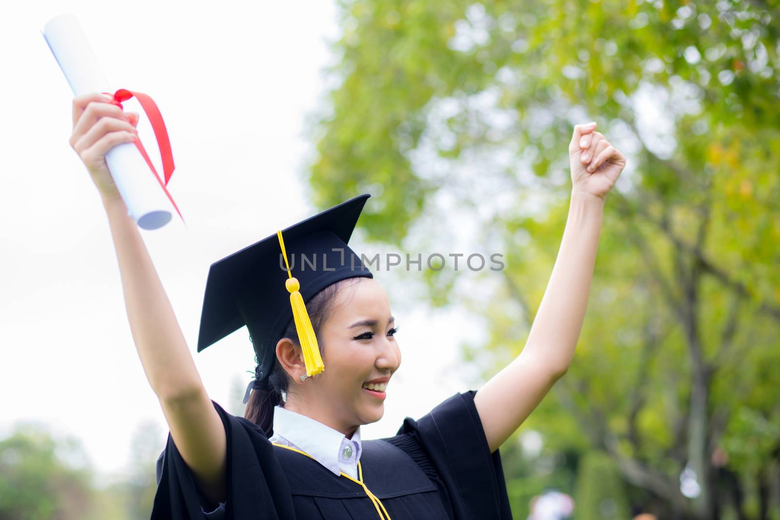 successful graduating student with nature background, Happy grad by nnudoo