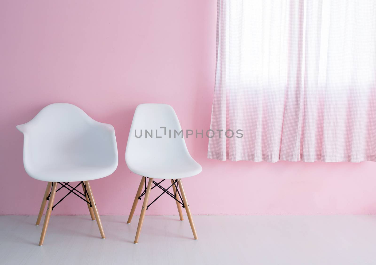 White chair over pink wall in the hipster interior modern room.