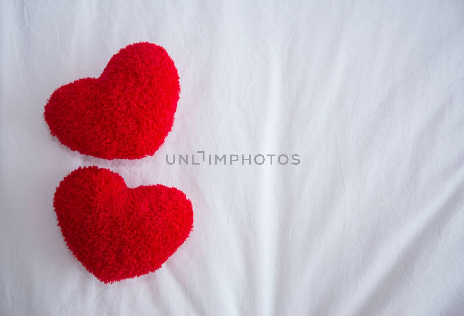 Romantic interior for Valentine's day with bed, pillows shaped h by nnudoo