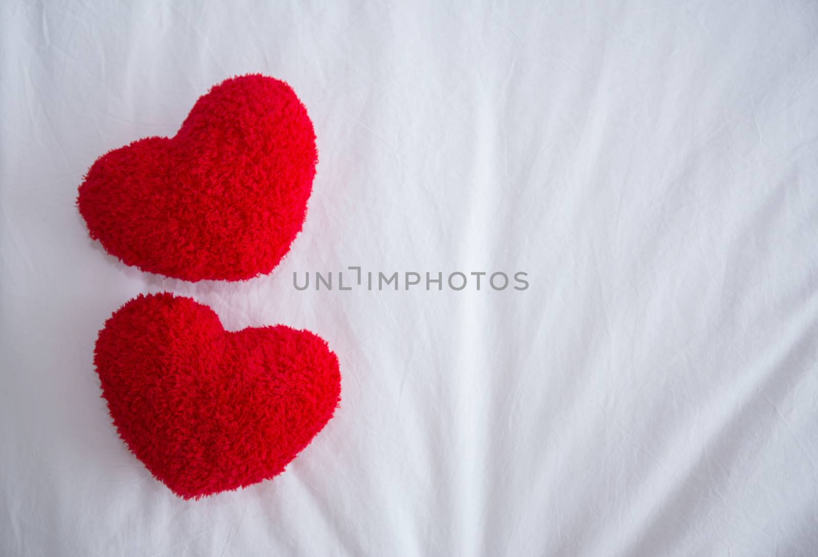 Romantic interior for Valentine's day with bed, pillows shaped heart