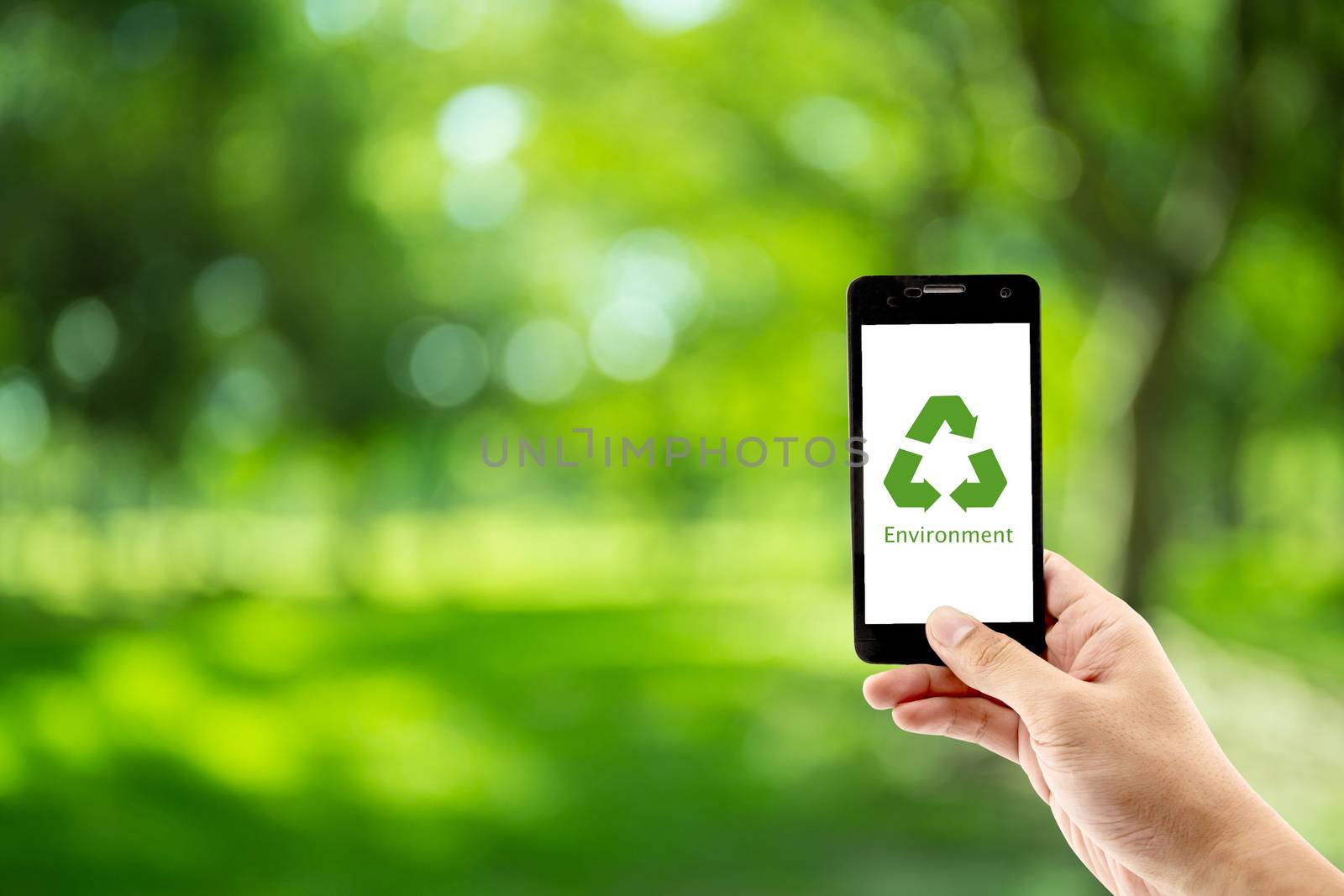 mobile phone holding hand with recycle symbol eco environment Ic by nnudoo