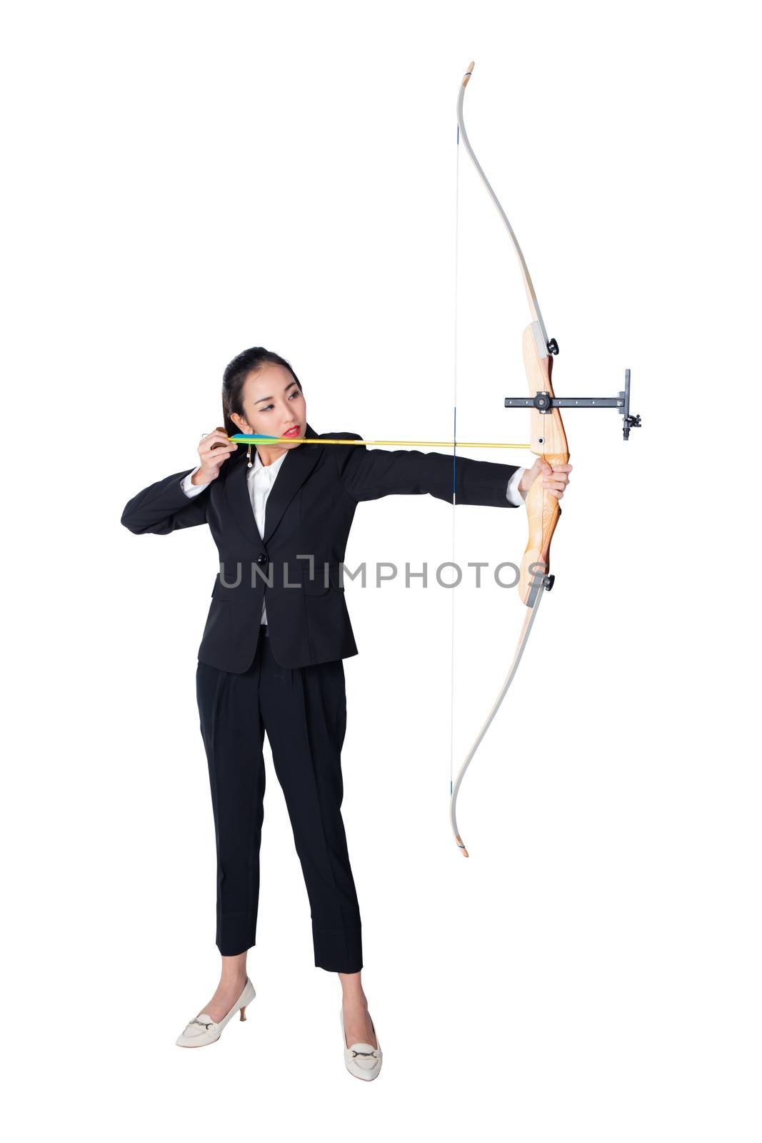Portrait of concentrated female with crossbow in hands over white background