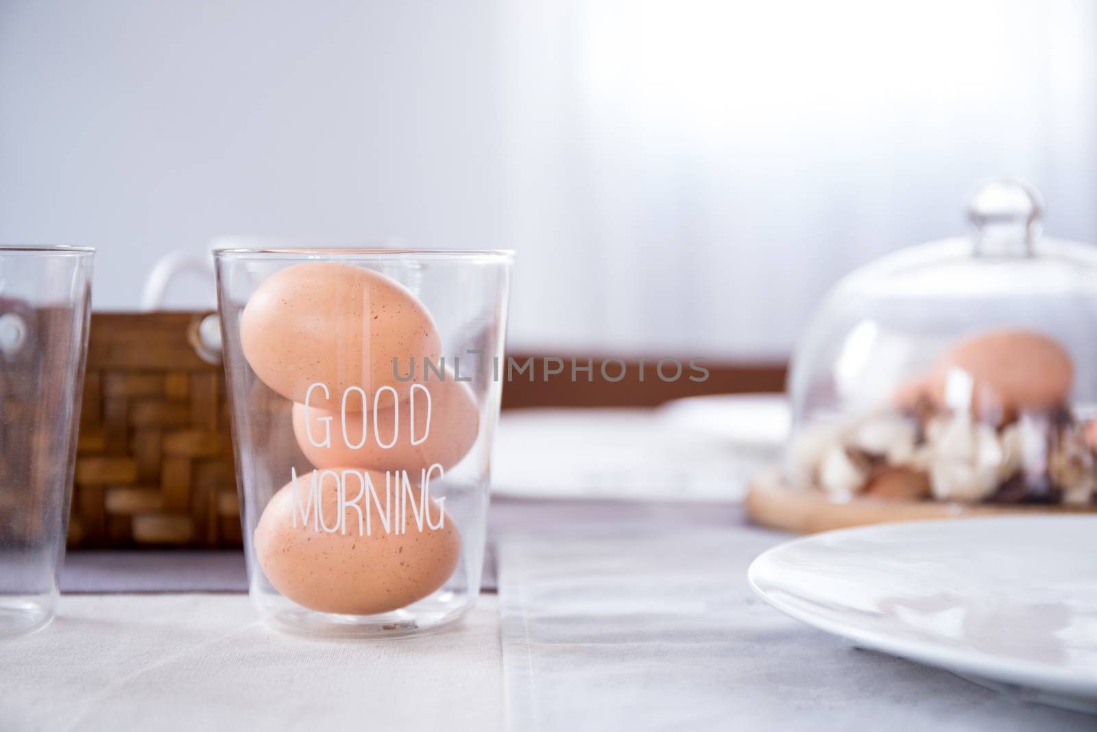 egg in glass with good morning text on table in the kitchen by nnudoo