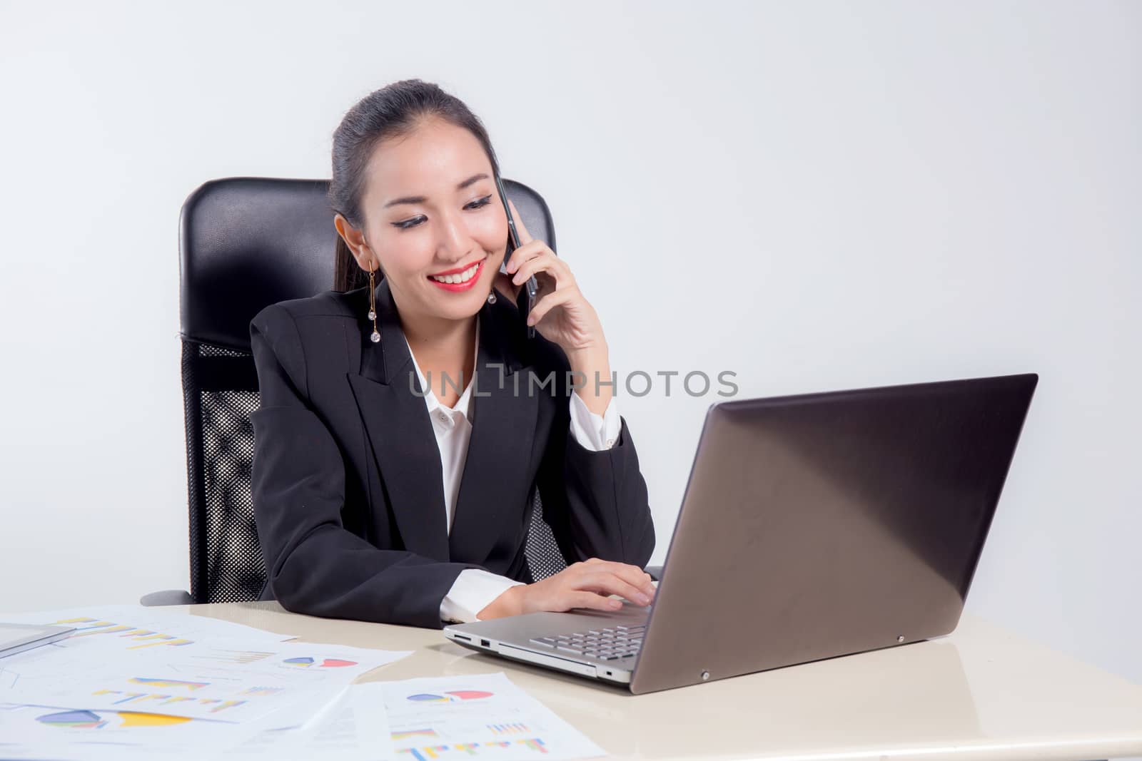 Young businesswoman working in office, typing, using computer an by nnudoo