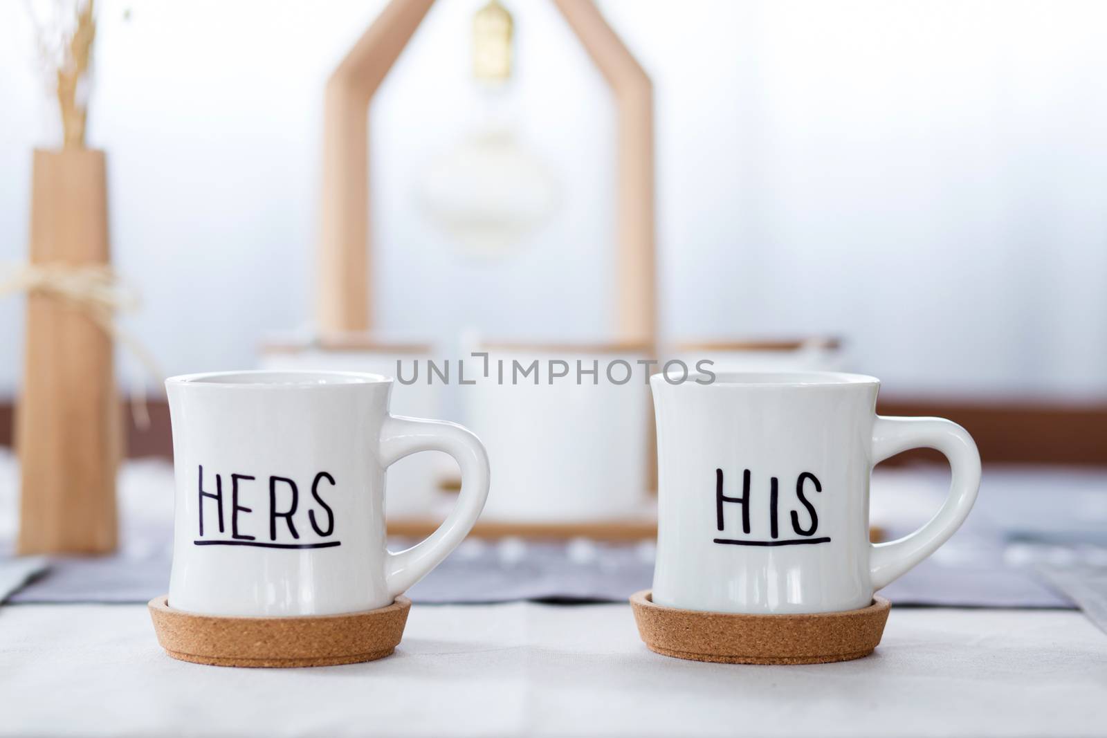 beautiful white cup with his, her text on table.