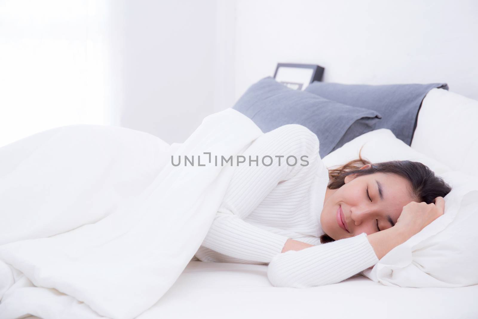 Beautiful girl on bed sleeping at home in the bedroom by nnudoo