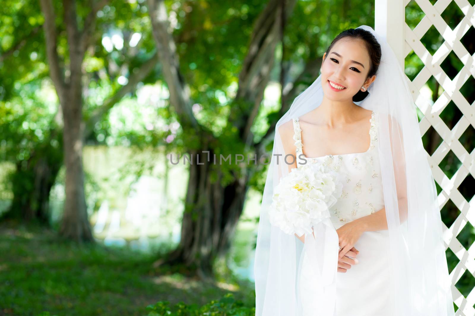 Asian bride at outdoor in a morning. by nnudoo