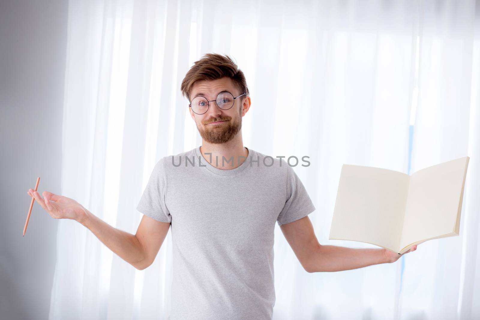 student man wear glasses holding a book empty with smiling happi by nnudoo
