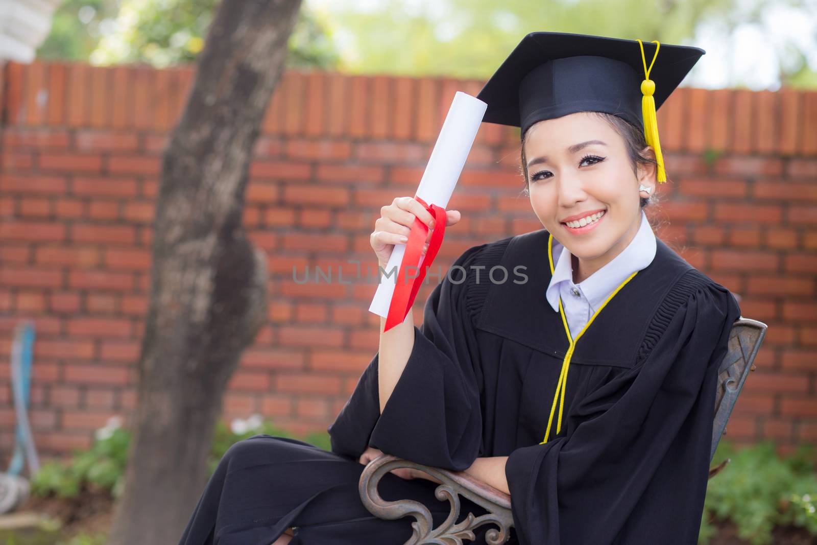 Happy graduated student girl hold certificate - congratulations of education success.