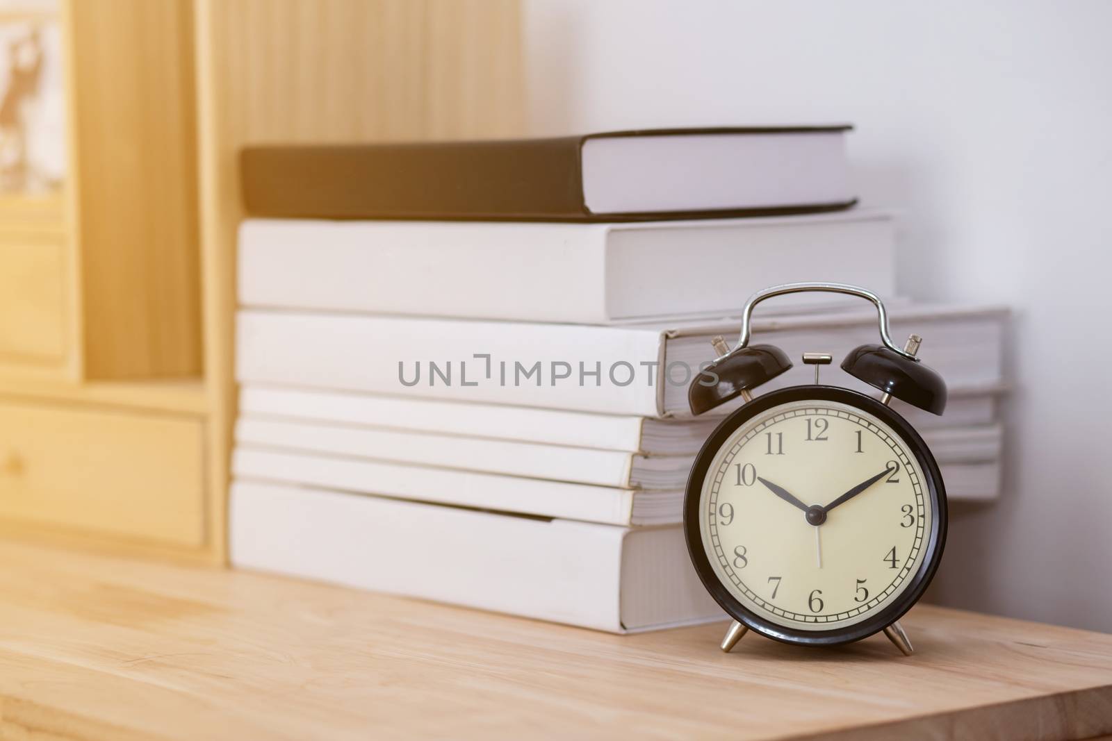 Vintage books and clock on wooden table by nnudoo