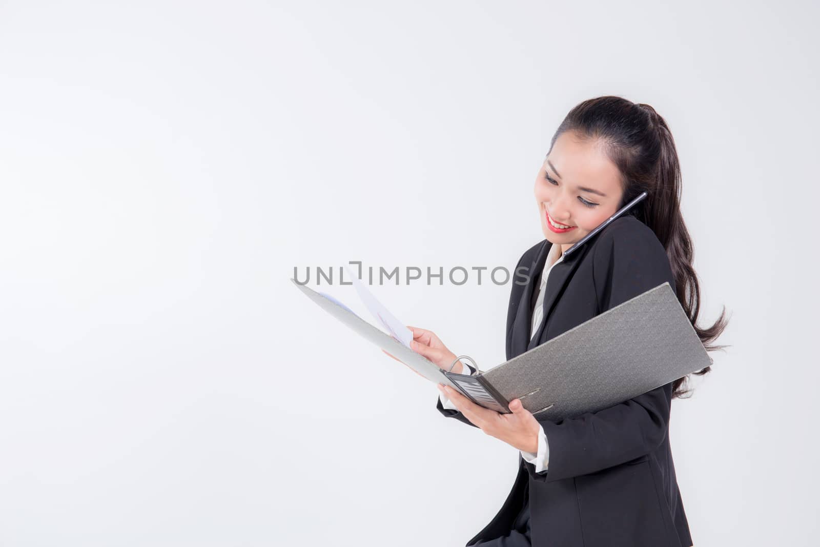 smiling businesswoman are talking by smartphone and holding file by nnudoo