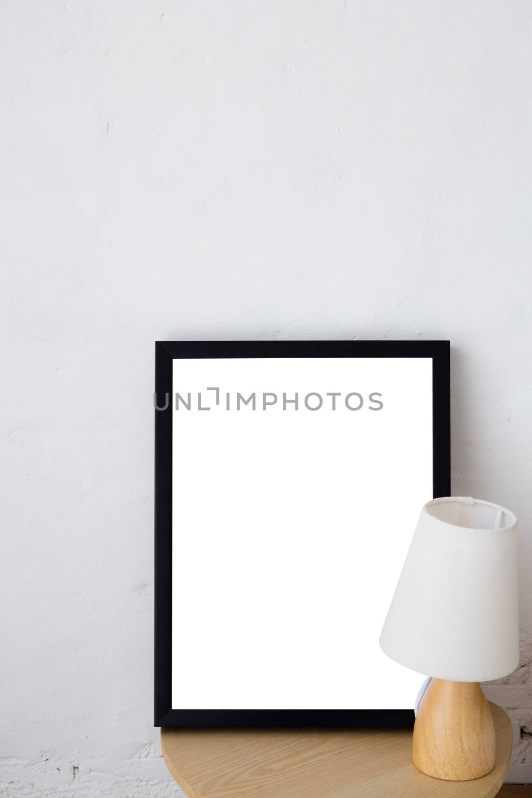 Empty black frame with place for text with lamp. Scandinavian hipster style room interior.