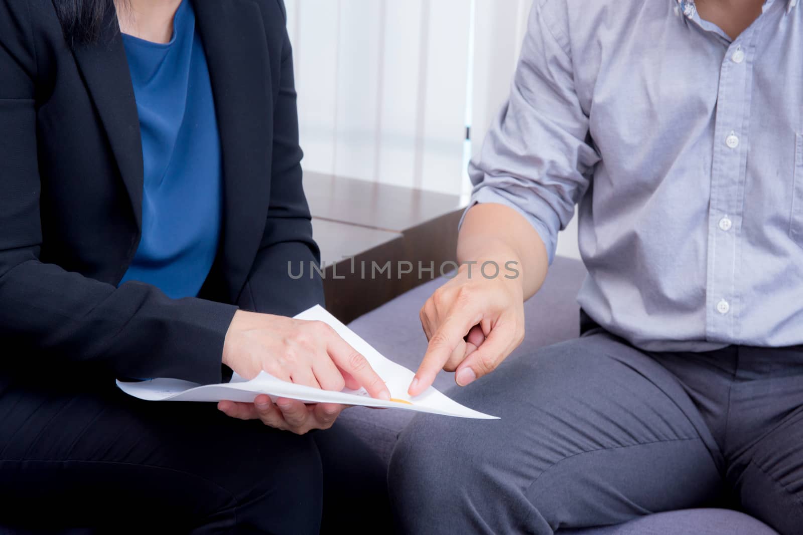 businessman and businesswoman talking about discussed document.
