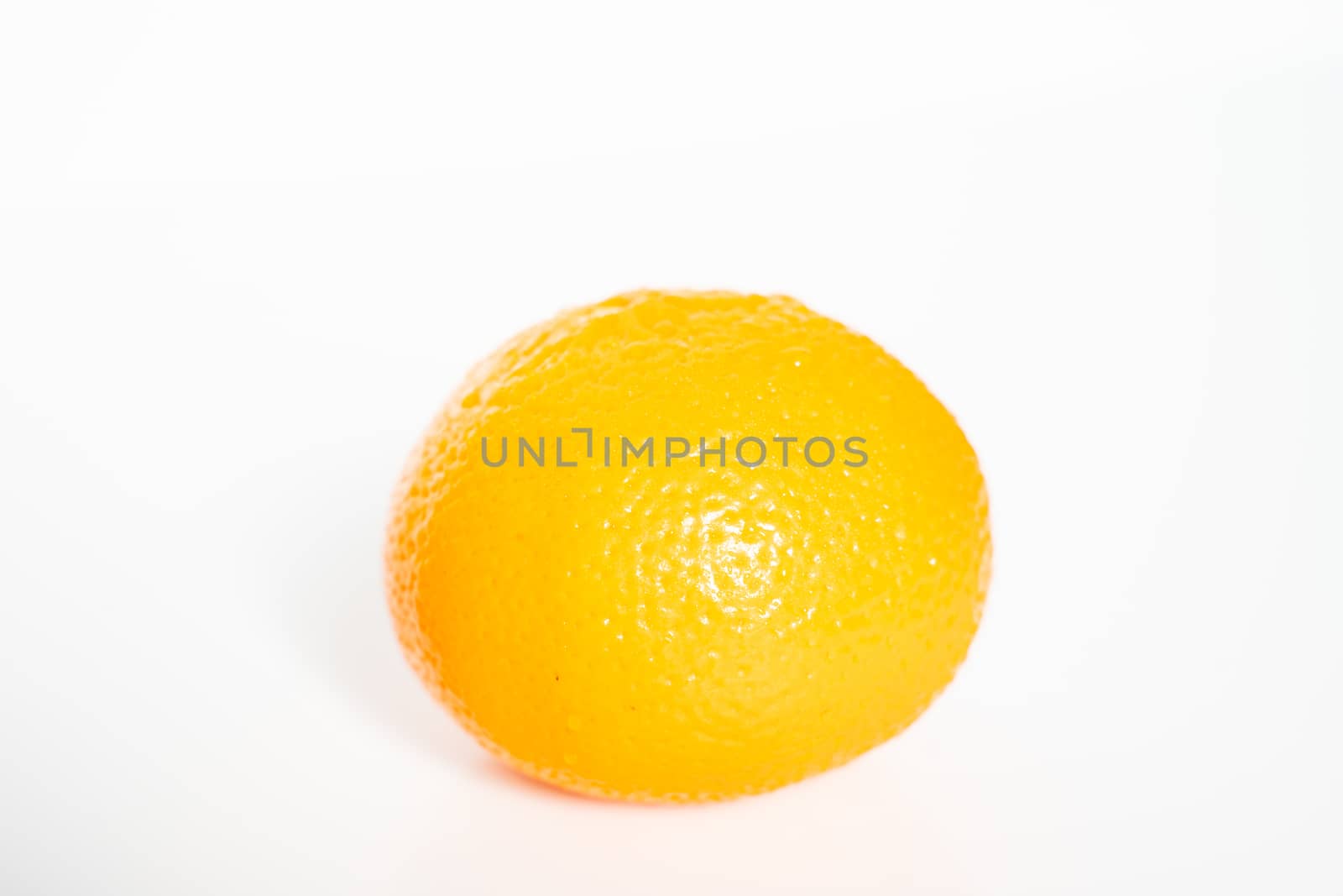 A whole orange against a plain white background