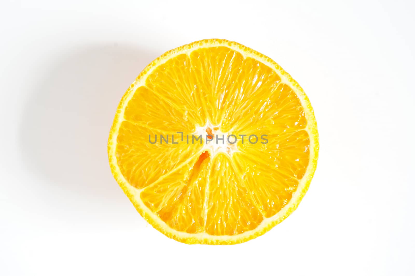 An orange sliced in half against a plain white background