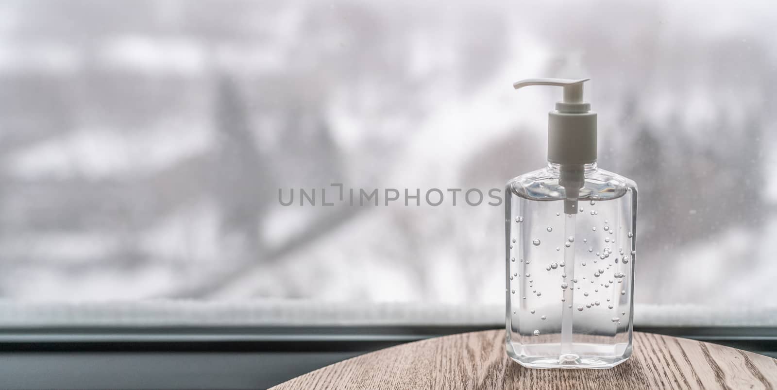 Coronavirus hand sanitizer gel to wash hands for flu virus prevention. Alcohol based antimicrobial disinfectant product for airport, hospital, healthcare and home panoramic banner background by Maridav