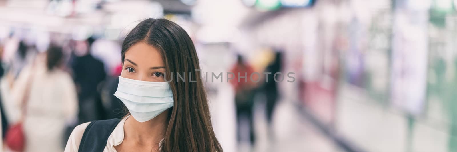 Coronavirus corona virus Asian woman wearing flu mask walking on work commute in public space transport train station or airport panoramic banner.