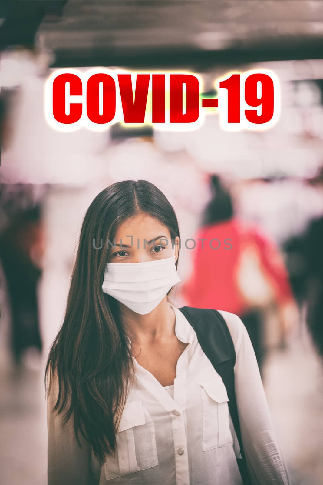 Coronavirus COVID-19 virus infection. Asian woman walking in airport crowd wearing virus surgical face mask with text title above. Vertical.