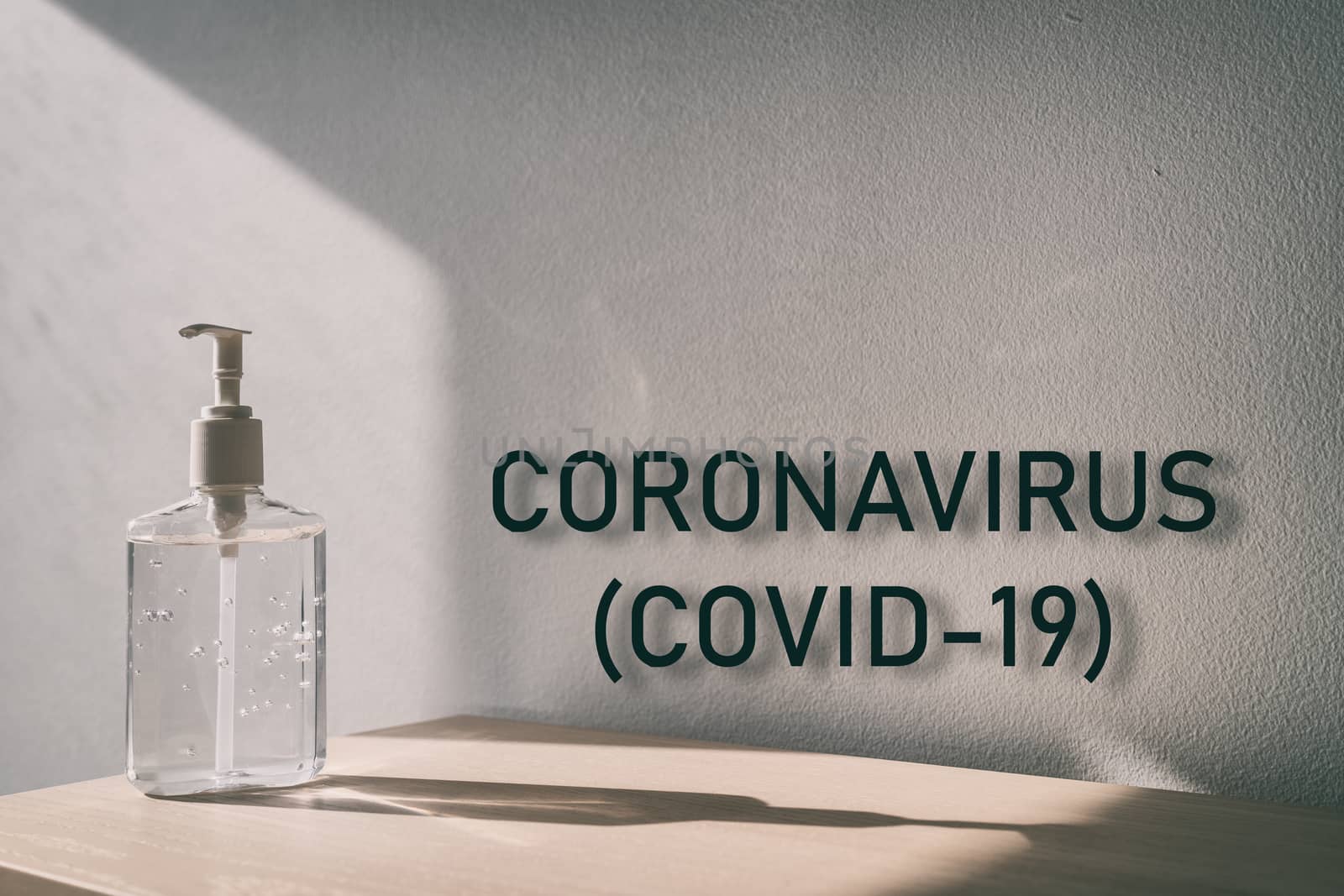 Coronavirus (COVID-19) text sign with hand sanitizer bottle background for global pandemic of corona virus outbreak by Maridav