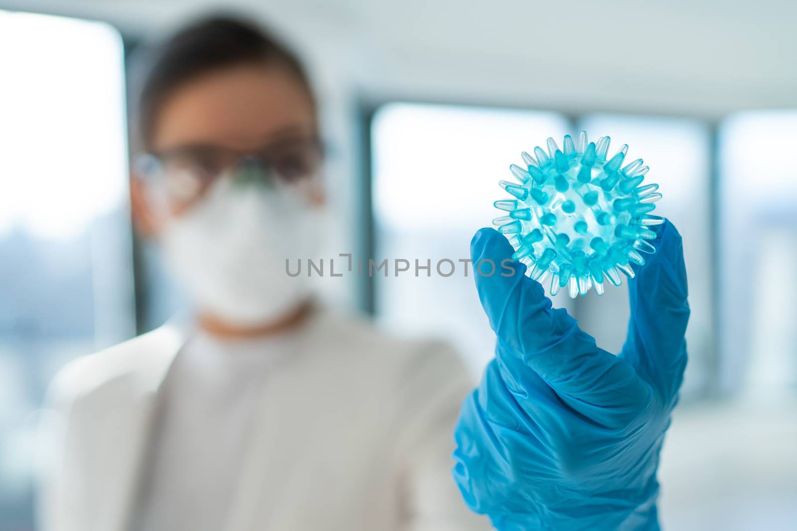 Coronavirus COVID-19 test lab research woman researching vaccine cure treatment holding corona virus blue model.