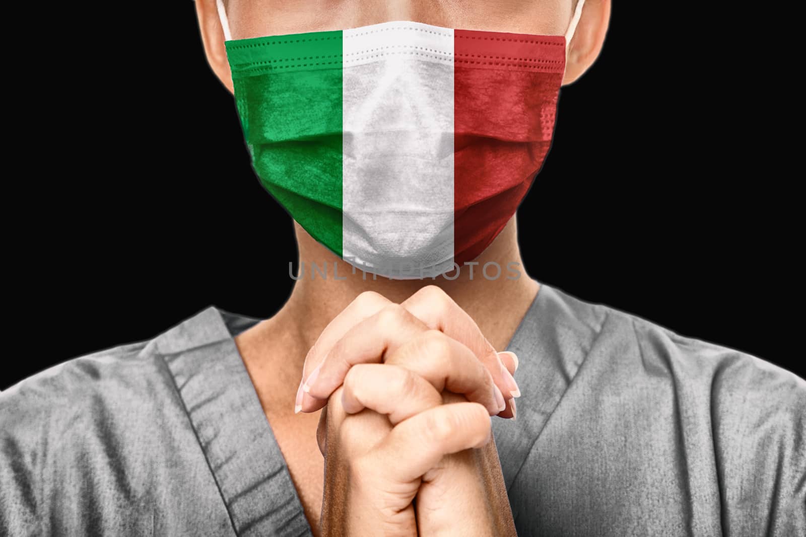 Praying for Italy. Coronavirus pandemic outbreak in Italy. Doctor praying for help. Young woman medical doctor surgeon or nurse portrait.