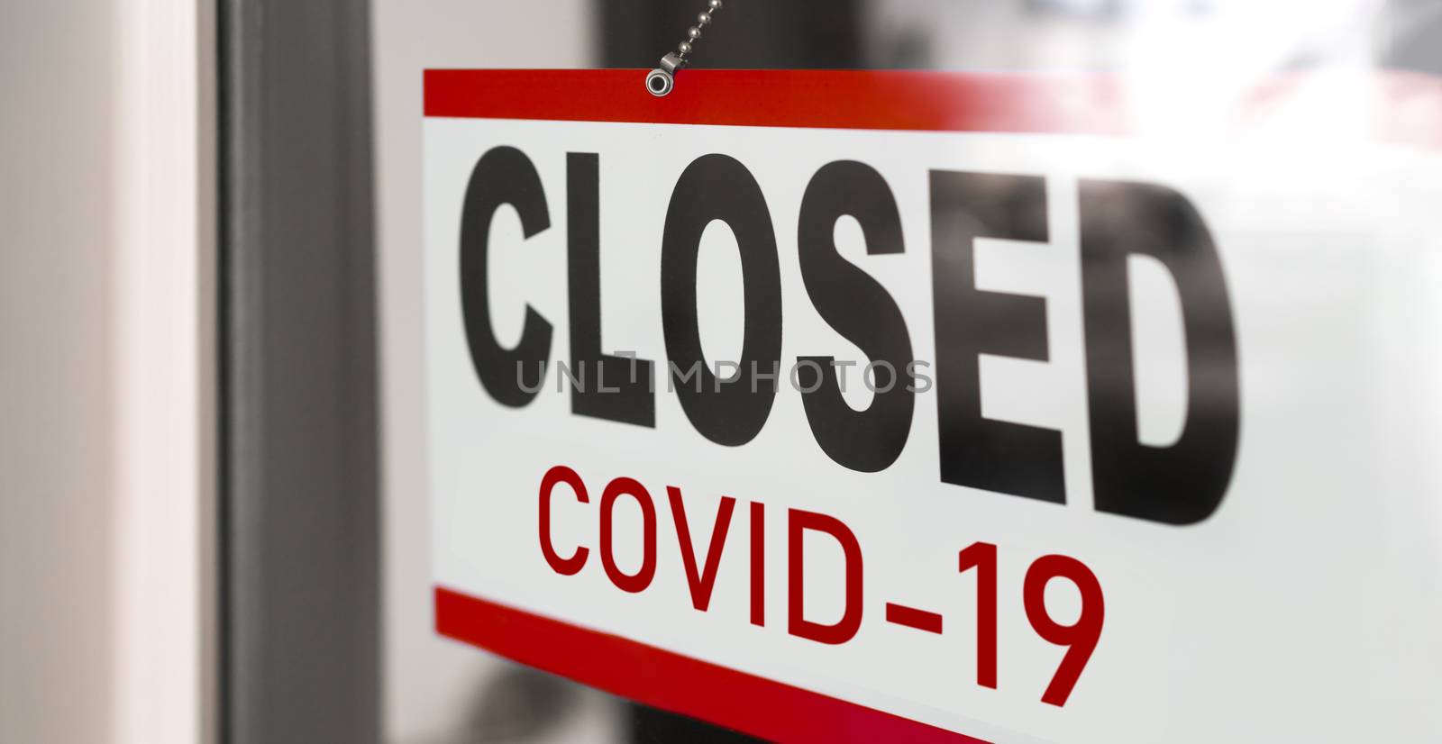 Closed businesses for COVID-19 pandemic outbreak, closure sign on retail store window banner background. Government shutdown of restaurants, shopping stores, non essential services by Maridav